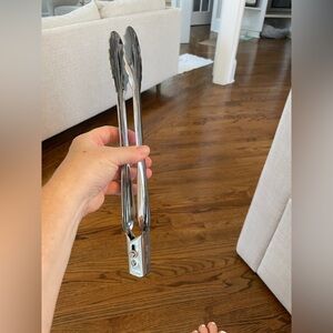 All clad large Stainless Steel Kitchen Tongs. They open when you move the knob.